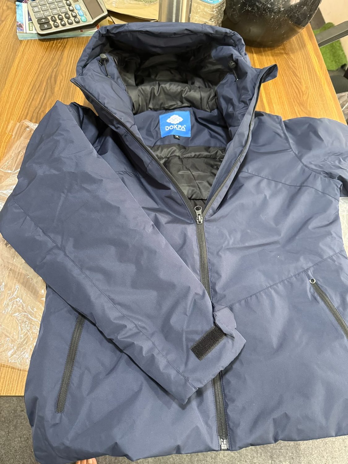 Close view of a jacket collar and the blue Dokpa label stitched inside it